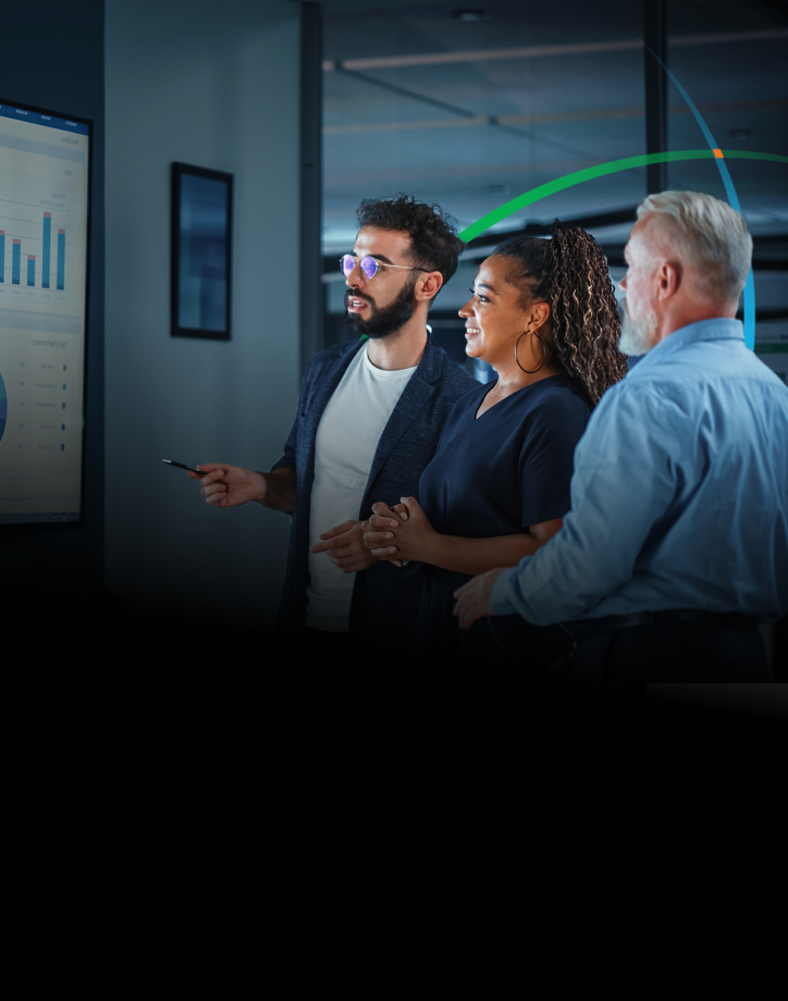 banner showing three business professionals having a discussion while looking at analytics dashboards on a large wall-mounted screen