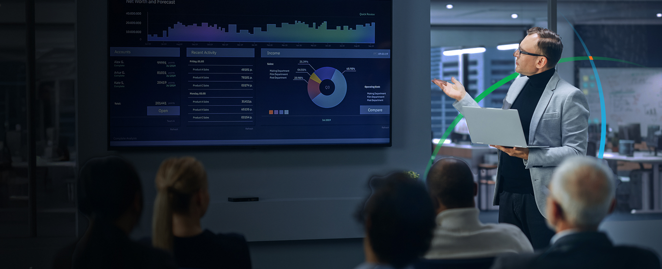 banner showing a man delivering a presentation to several people while pointing at a large screen displaying charts and graphs