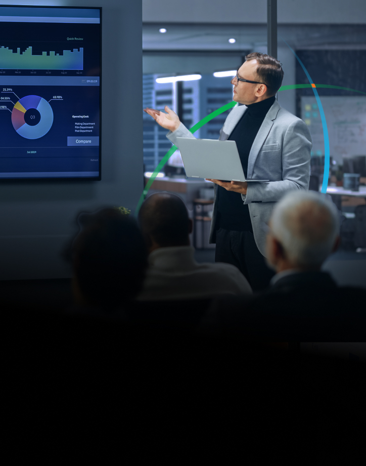 banner showing a man delivering a presentation to several people while pointing at a large screen displaying charts and graphs