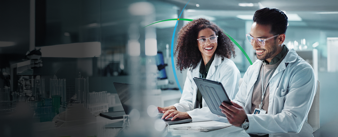 banner showing two pharma professionals in a lab having a discussion while looking at a tablet screen