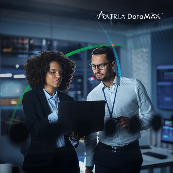 a man and a woman having a discussion while looking at a laptop screen