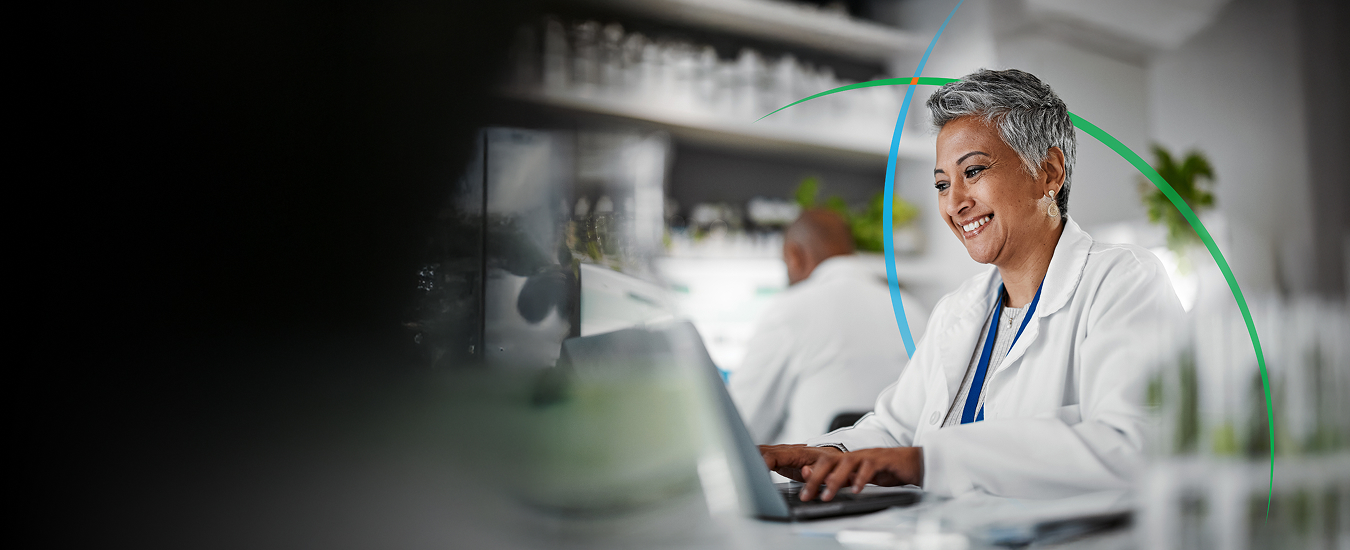 banner showing a smiling medical professional using a laptop