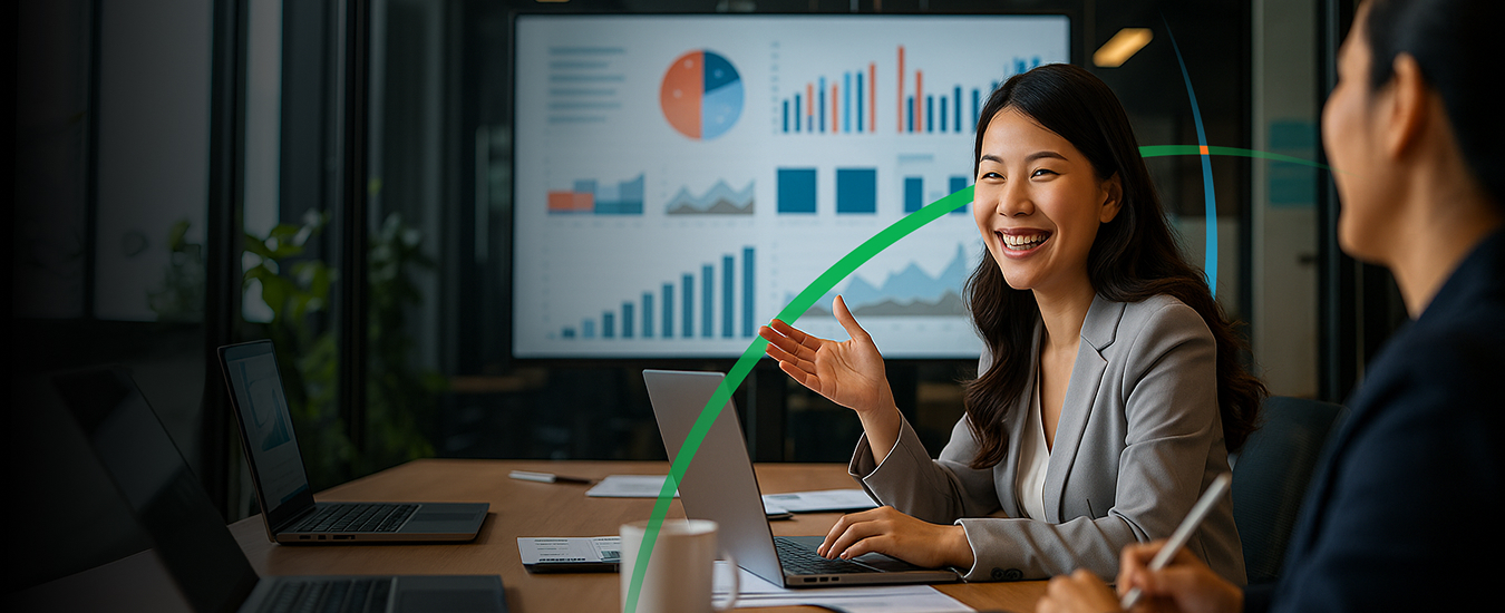 banner showing two business professionals having a discussion with a large screen displaying graphs in the background