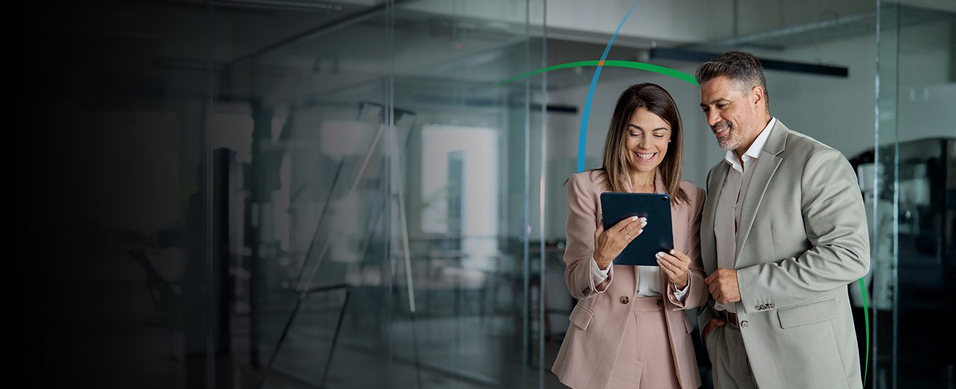 banner showing two business professionals smiling while looking at a tablet screen