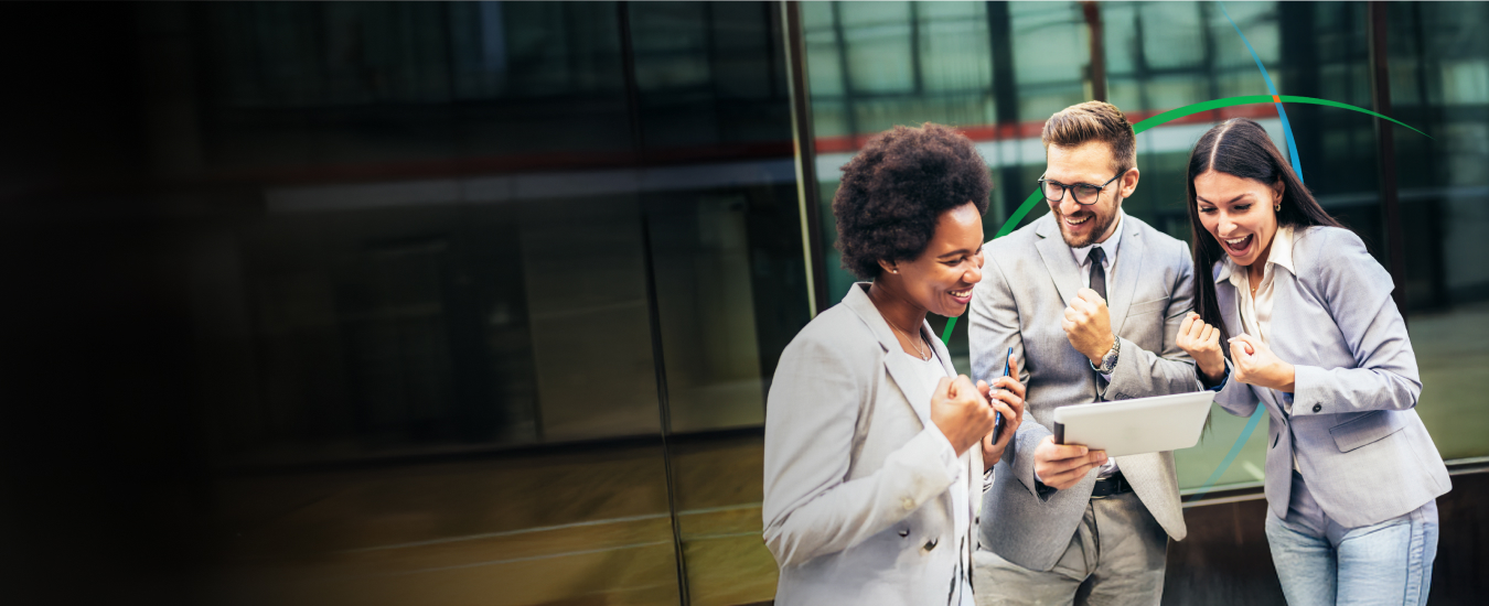 banner showing employees celebrating success while looking at a tablet screen