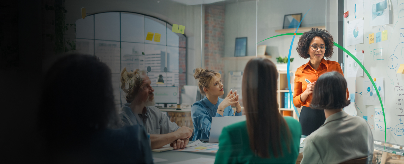 banner showing a team having a discussion in a conference room with information displayed on a whiteboard