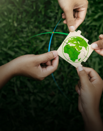 banner showing four hands bringing puzzle pieces together to form a picture depicting the earth