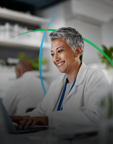 banner showing a smiling medical professional using a laptop