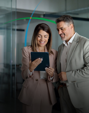 banner showing two business professionals smiling while looking at a tablet screen