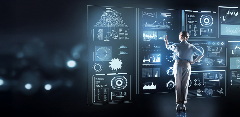 a woman interacting with several analytics dashboards displayed on a translucent wall