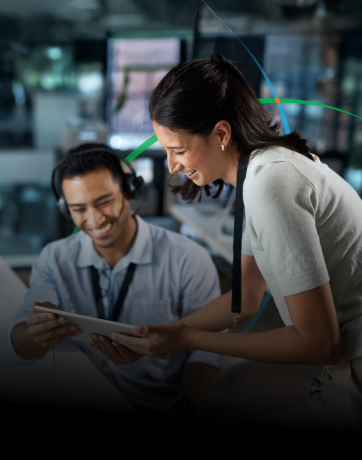 banner showing two employees with happy expressions looking at a tablet screen