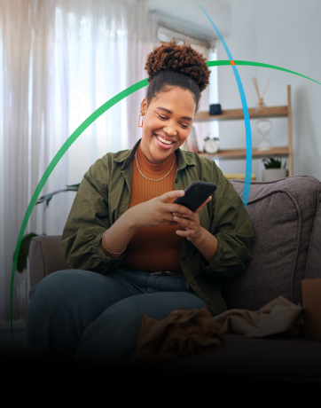 banner showing a smiling woman looking at her phone while sitting on a couch